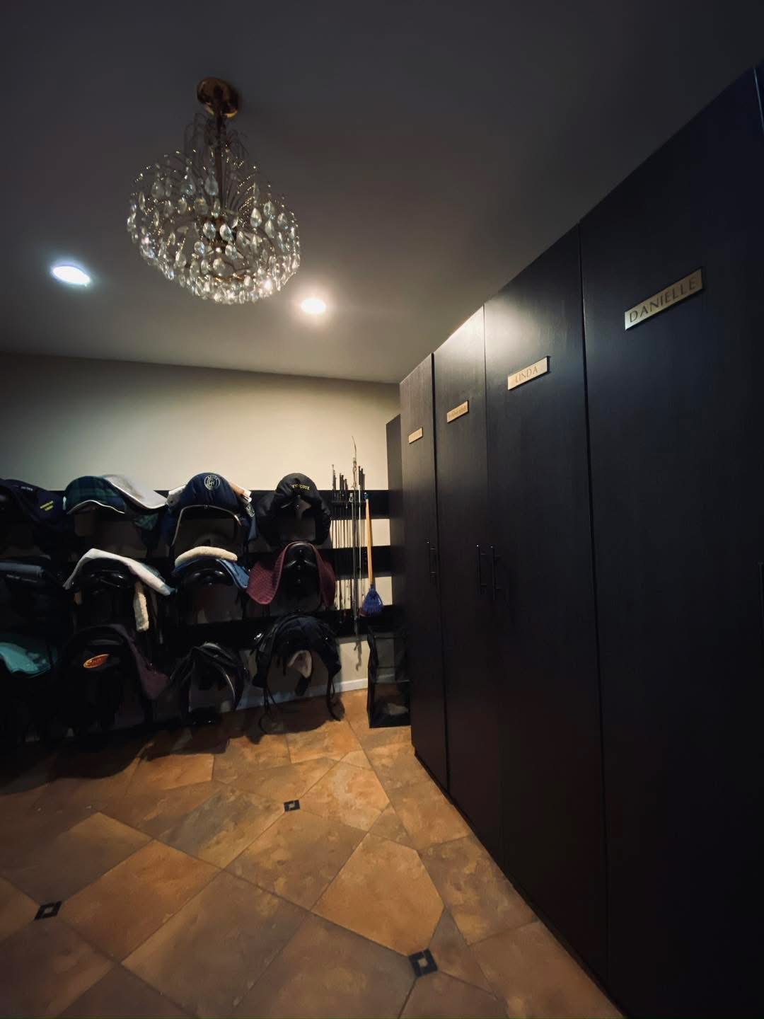 Elegant tack room with crystal chandelier and engraved personal lockers