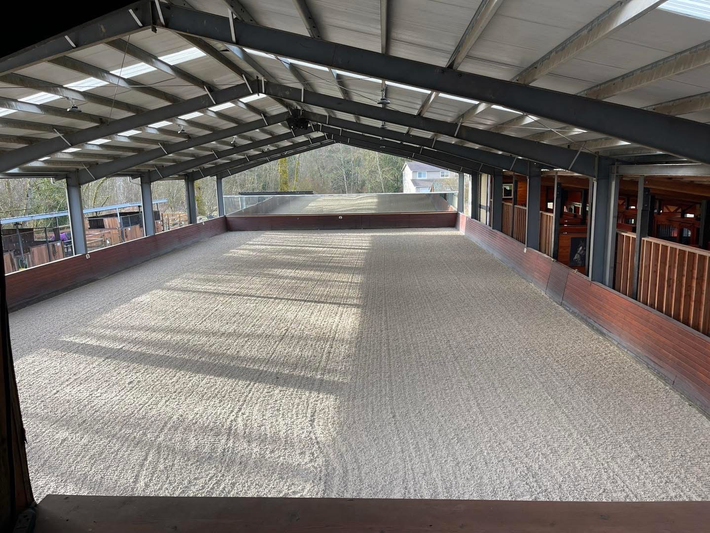 Covered riding arena with sandy footing at Off Broadway Farm