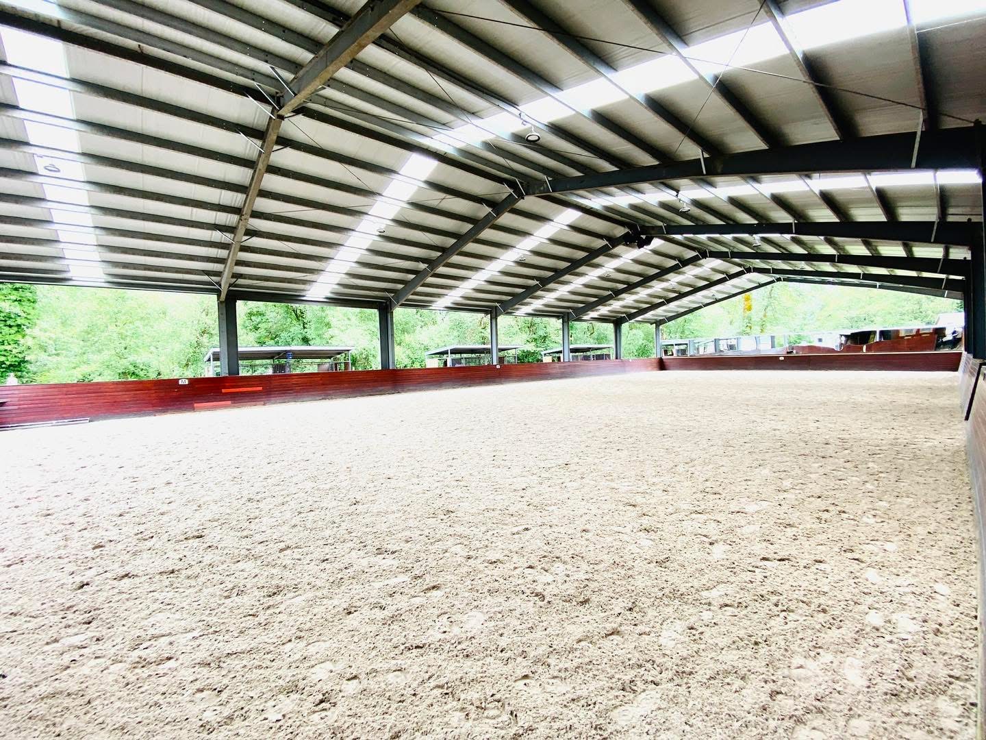 Full-size indoor dressage arena with premium footing at Off Broadway Farm